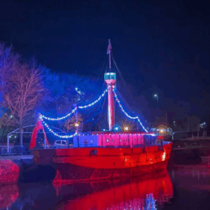 A boat in Bristol's Floating Harbour decorated with Christmas lights. It is about to set sail for a festive boat parade